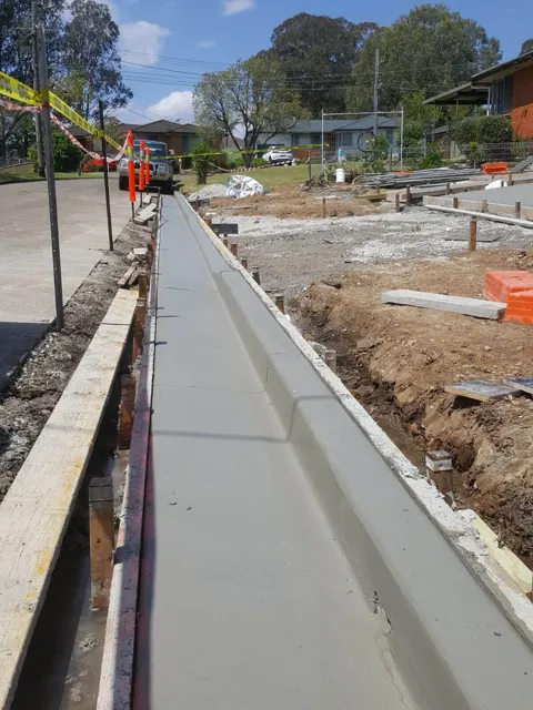 New concrete kerb and gutter with formwork still in place