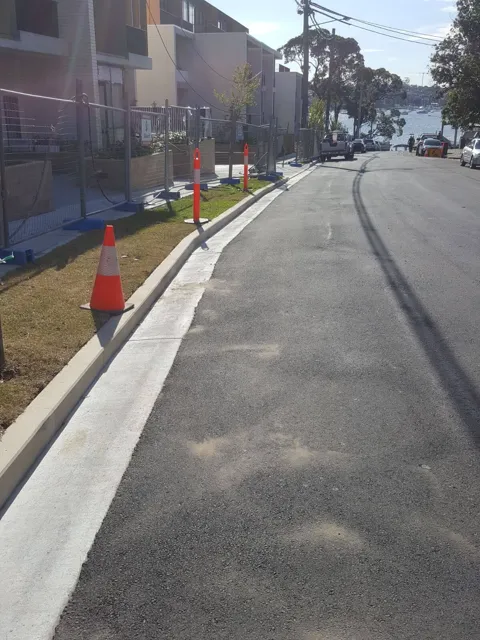 New kerb alongside a fresh asphalt roadway