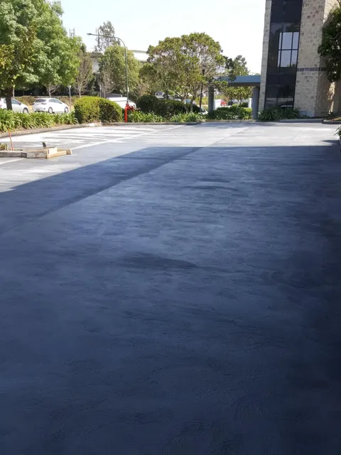 Freshly sealed asphalt car park