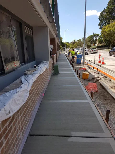 New concrete footpath beside a residential building