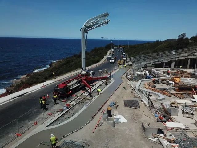 Concrete pump and crew on a coastal road upgrade in Sydney